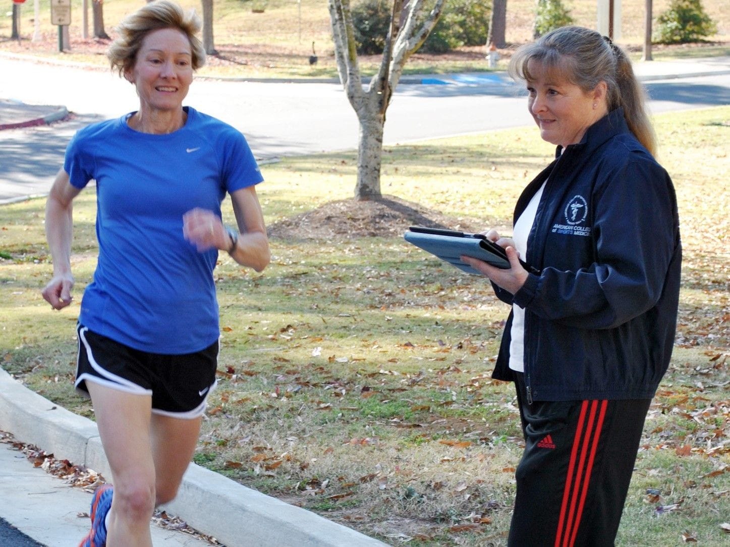 Woman running while being coached